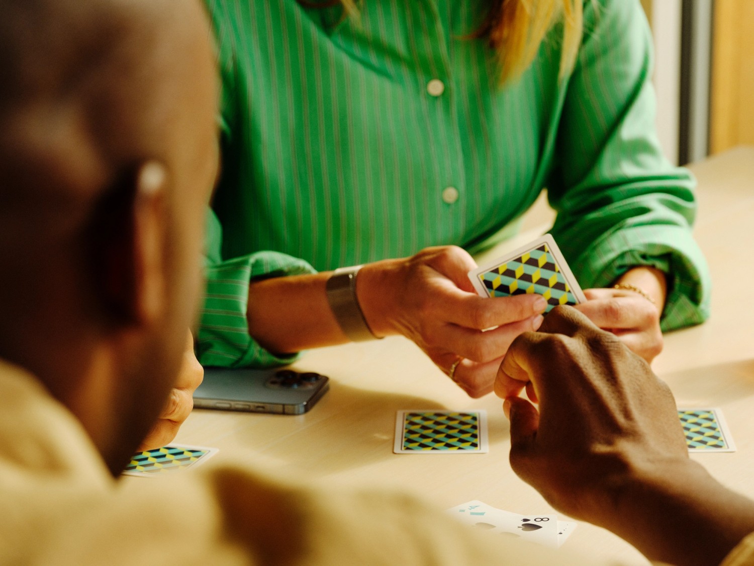 Two people playing cards at a table